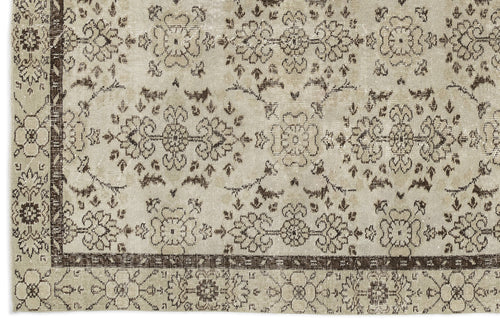 Load image 1 in gallery view. Beige and dark brown distressed rug with a traditional floral medallion pattern and a wide decorative border.
