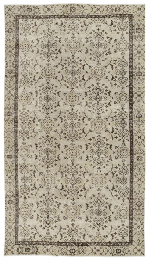 Load image 1 in gallery view. Beige and dark brown vintage-style rug with a repeating floral medallion pattern and a decorative border.