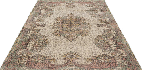 Load image 1 in gallery view. Beige vintage-style rug with a distressed floral medallion pattern in muted pink, sage green, and brown tones.