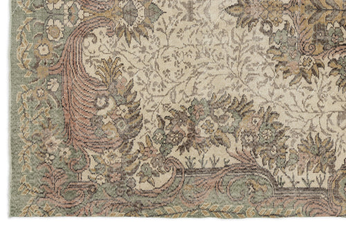 Load image 1 in gallery view. Distressed traditional rug with a floral medallion pattern in muted sage green, dusty rose, and beige tones.