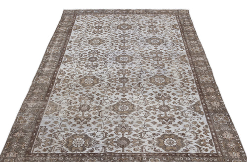Load image 1 in gallery view. Brown and cream vintage-style rug with a distressed floral medallion pattern and a wide decorative border.