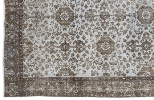 Load image 1 in gallery view. Distressed brown and light blue rug with a traditional floral medallion pattern and a wide decorative border.