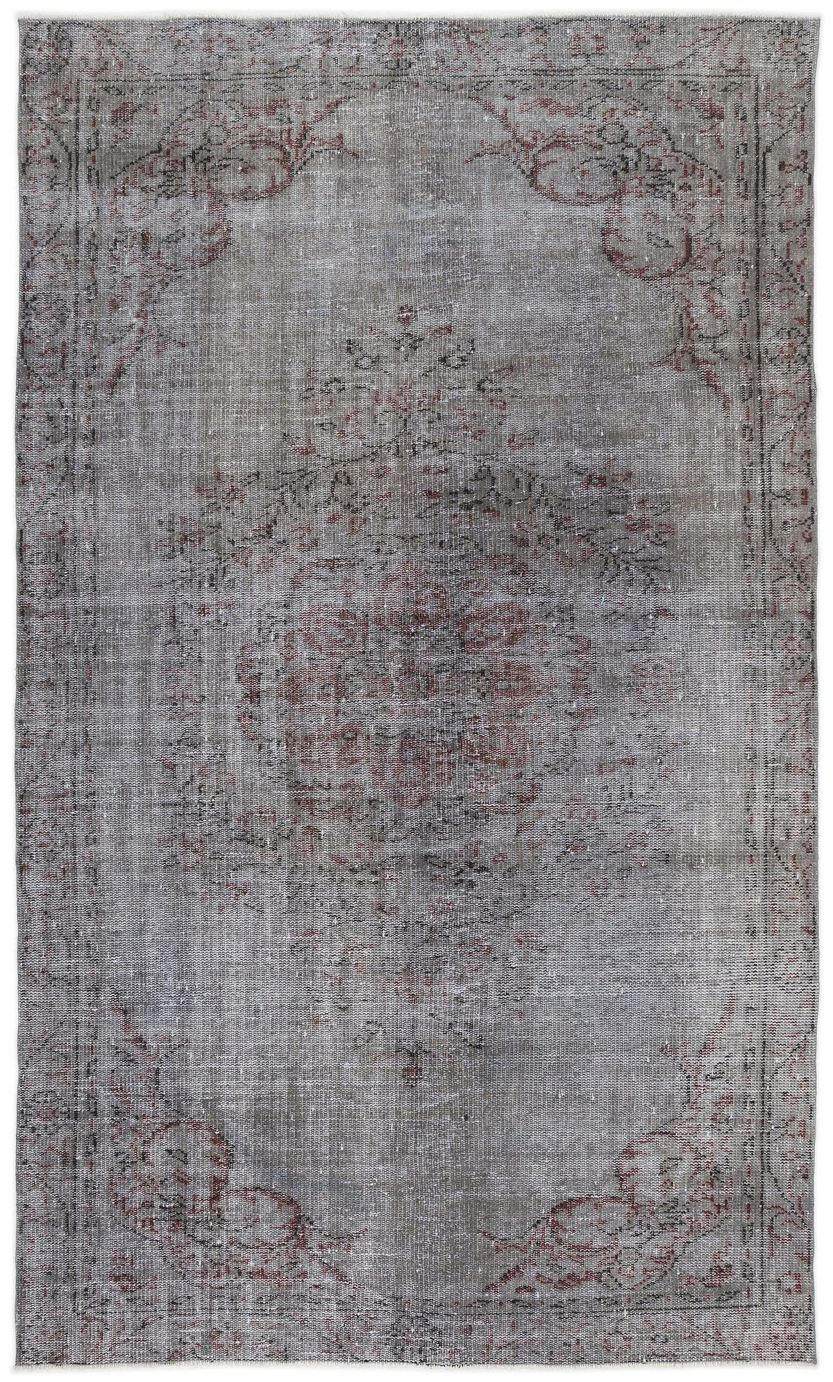 Distressed grey and charcoal rug with a faded central medallion and ornate floral border in muted red tones.