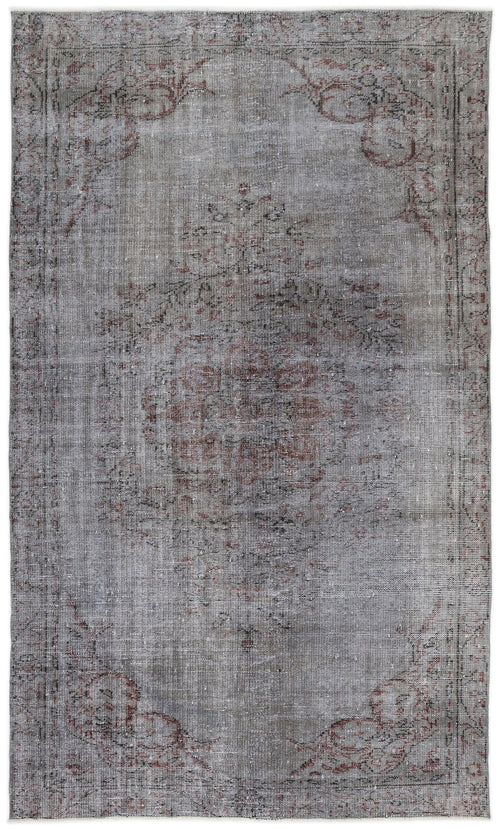 Load image 1 in gallery view. Distressed grey and charcoal rug with a faded central medallion and ornate floral border in muted red tones.
