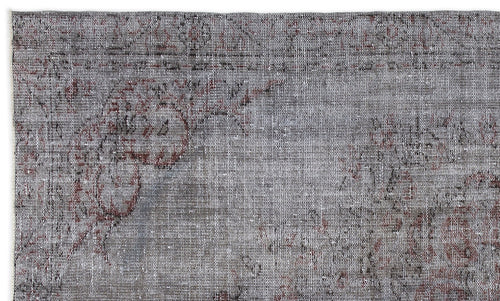 Load image 1 in gallery view. Grey and charcoal distressed rug with a faded traditional floral medallion pattern.