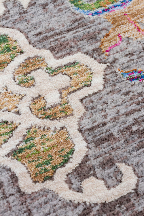 Load image 1 in gallery view. Grey textured rug with cream, tan, and green floral medallion patterns and small accents of bright pink and blue.