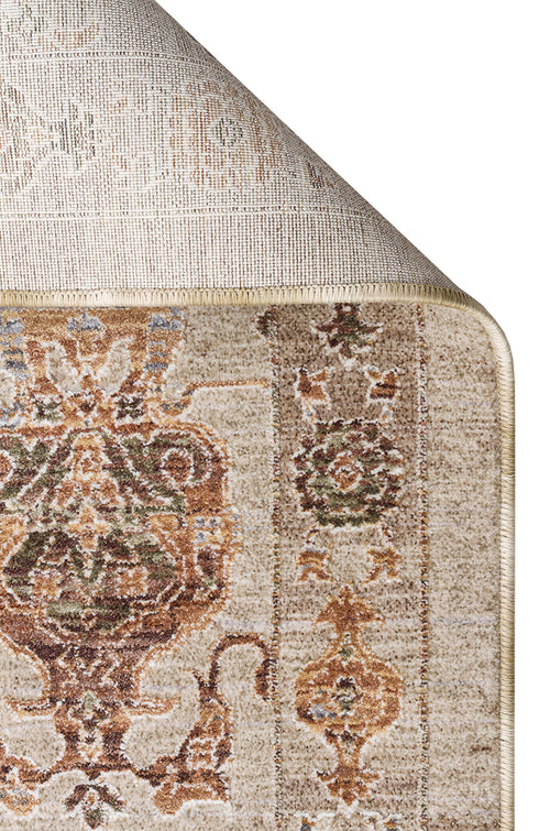 Load image 1 in gallery view. Beige area rug with a traditional floral medallion pattern in rust, olive, and cream, shown with a folded corner.