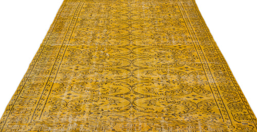 Load image 1 in gallery view. Mustard yellow rug with a distressed black floral medallion pattern and a decorative border.