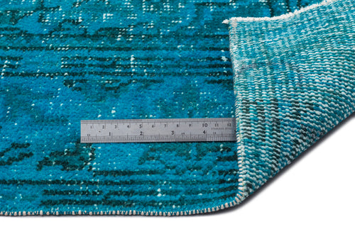 Load image 1 in gallery view. Teal and dark blue distressed rug with a white woven backing, shown with a metal ruler for scale.