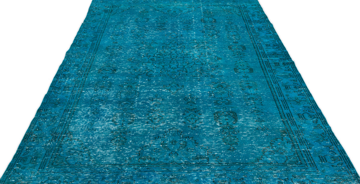 Teal distressed area rug with a faded traditional medallion pattern and a bordered edge on a white background.