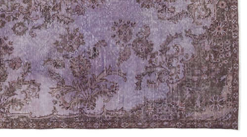 Load image 1 in gallery view. Lavender and dark brown distressed rug with a traditional floral medallion pattern.