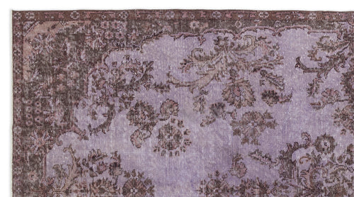 Load image 1 in gallery view. Distressed lavender and dark brown rug with a traditional floral medallion pattern and a wide decorative border.
