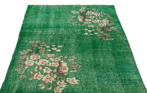 Load image 1 in gallery view. Emerald green distressed rug with white and brown floral vase motifs on a white background.