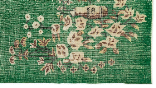 Load image 1 in gallery view. Emerald green rug with a distressed floral pattern in cream and brown, featuring a woven texture.