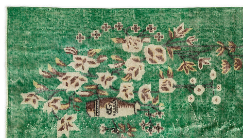 Load image 1 in gallery view. Emerald green rug with a distressed floral pattern in cream and brown.