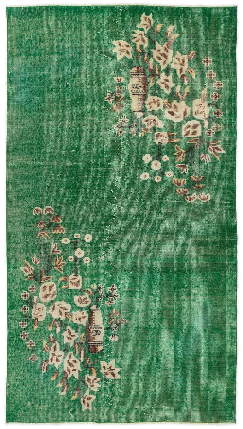 Load image 1 in gallery view. Emerald green distressed rug with cream and brown floral branch motifs in opposite corners.