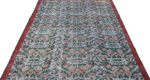 Load image 1 in gallery view. Distressed grey rug with a repeating floral pattern in red and green, featuring solid red side borders.