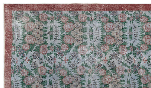 Load image 1 in gallery view. Distressed light blue rug with a floral pattern in red and green, featuring a solid red border.