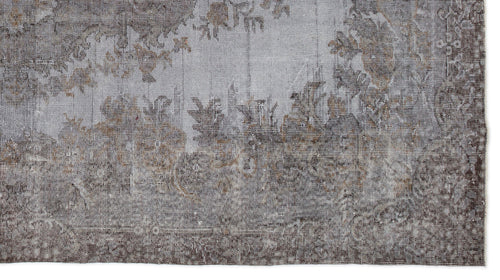 Load image 1 in gallery view. Grey and brown distressed rug with a faded traditional floral medallion pattern on a white background.