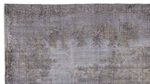 Load image 1 in gallery view. Grey and brown distressed vintage-style rug with a faded, low-pile floral pattern on a white background.