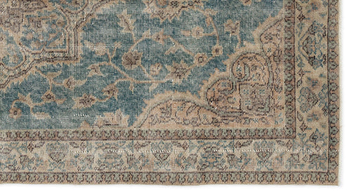 Load image 1 in gallery view. Blue and beige traditional rug with a distressed floral medallion pattern and a detailed border.