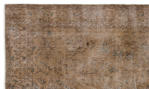 Load image 1 in gallery view. Distressed brown rug with a faded traditional floral medallion pattern and subtle blue accents on a white background.