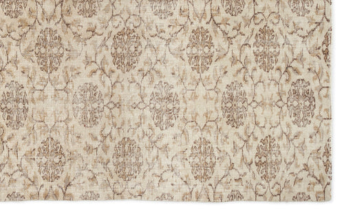 Load image 1 in gallery view. Beige and taupe rug with a distressed, repeating floral medallion pattern.