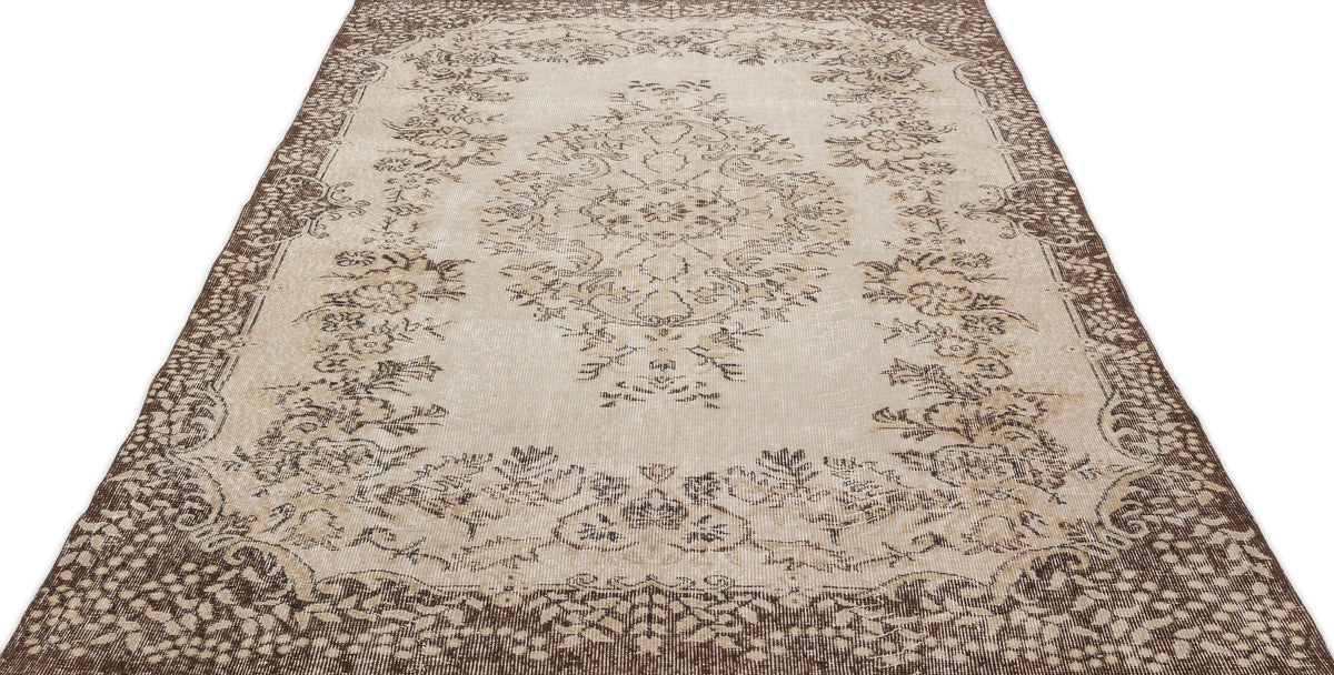 The Petida - Vintage Medallion Rug (5'8 x 9'5) features an ornate floral pattern in beige and brown with a detailed central medallion and decorative borders, bringing vintage charm to any space.