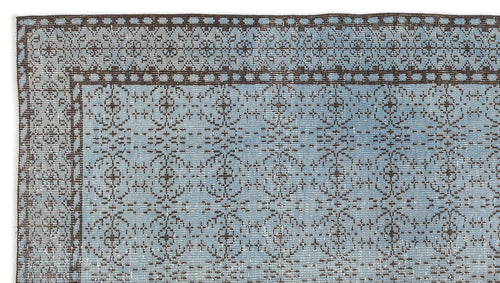 Load image 1 in gallery view. Light blue rug with a dark brown traditional floral medallion border and repeating geometric pattern.
