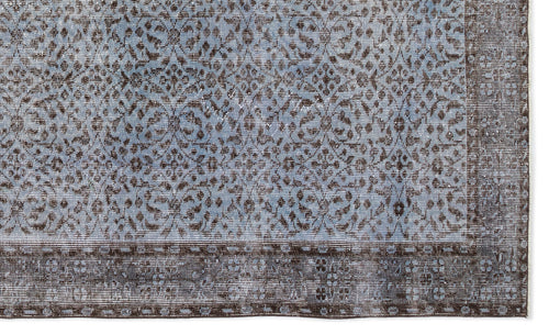 Load image 1 in gallery view. Blue and dark brown rug with a distressed traditional floral medallion pattern and a wide decorative border.