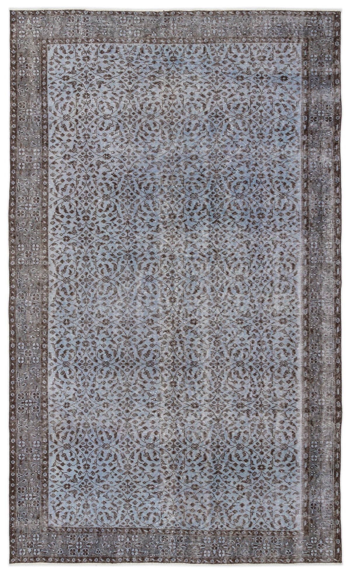 Blue and charcoal grey vintage-style rug with a distressed floral medallion pattern and a wide decorative border.