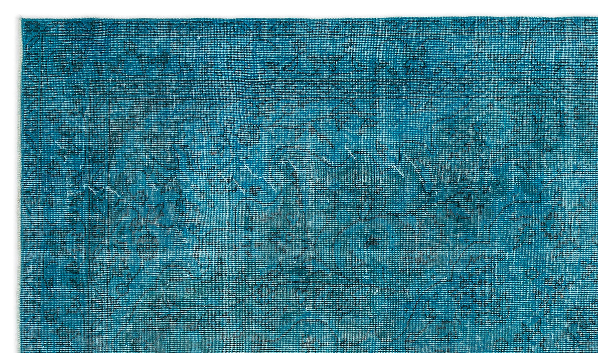 Teal vintage-style rug with a distressed, faded traditional floral medallion pattern and a thin border.