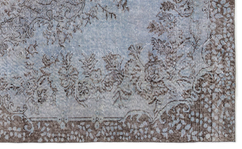 Load image 1 in gallery view. Light blue and dark brown distressed rug with a traditional floral medallion pattern and a detailed border.