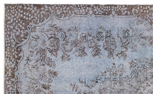 Load image 1 in gallery view. Distressed light blue and brown rug with a traditional floral medallion pattern and ornate border.