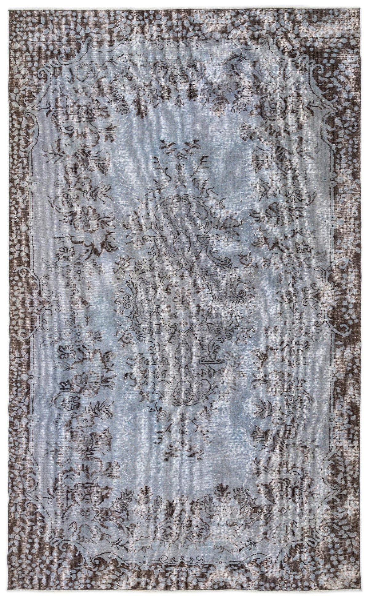 Light blue and brown distressed traditional rug with a central floral medallion and ornate border.