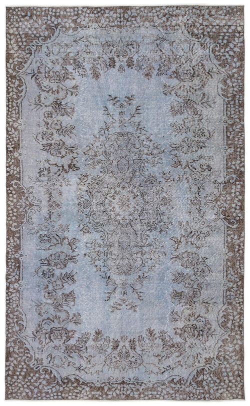 Load image 1 in gallery view. Light blue and brown distressed traditional rug with a central floral medallion and ornate border.