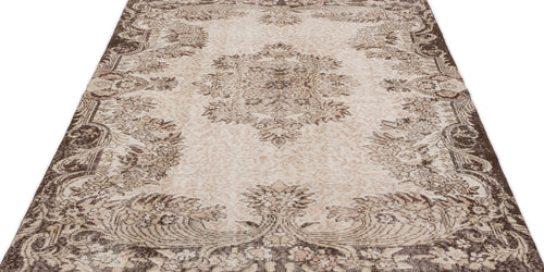 Load image 1 in gallery view. Beige and brown vintage-style rug with a central floral medallion and ornate border on a white background.