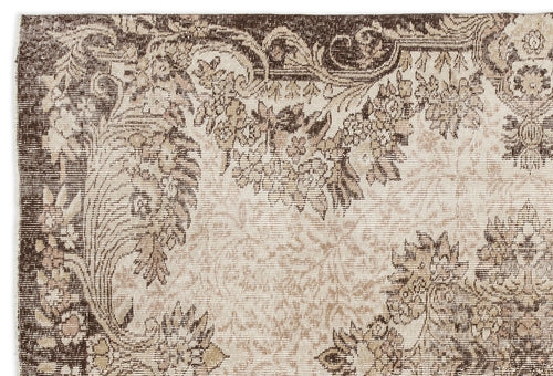 Load image 1 in gallery view. Brown and beige rug with a distressed traditional floral medallion pattern and ornate border.