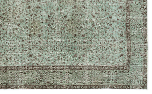 Load image 1 in gallery view. Distressed mint green and brown rug with a traditional floral medallion pattern and a wide decorative border.