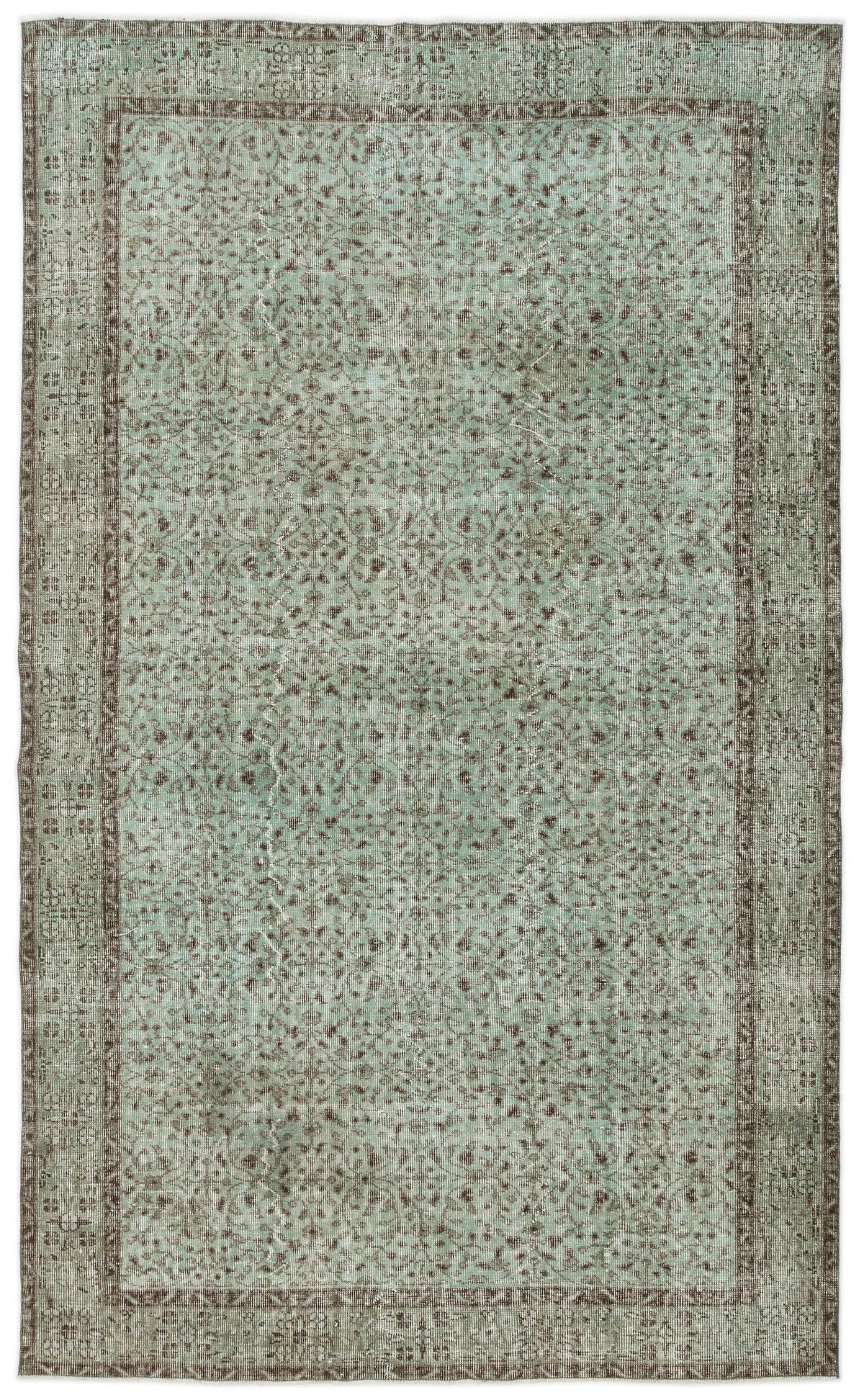 Sage green and brown distressed vintage-style rug with an intricate floral medallion pattern and a wide border.