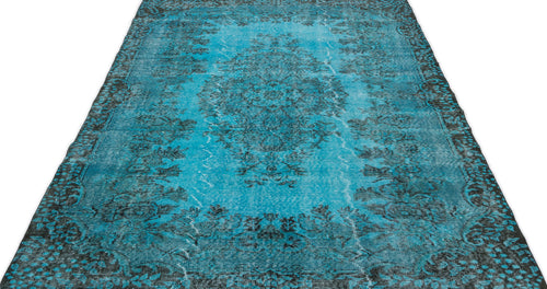 Load image 1 in gallery view. Distressed turquoise and black rug with a traditional floral medallion pattern on a white background.
