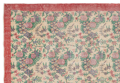 Load image 1 in gallery view. Beige rug with a red border and a repeating floral pattern in pink, green, and blue.