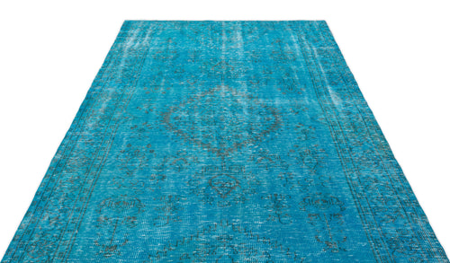Load image 1 in gallery view. Bright turquoise distressed rug with a faded dark grey traditional medallion pattern on a white background.