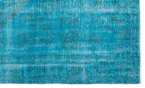 Load image 1 in gallery view. Bright turquoise rug with a distressed, faded floral medallion pattern and dark grey border details.