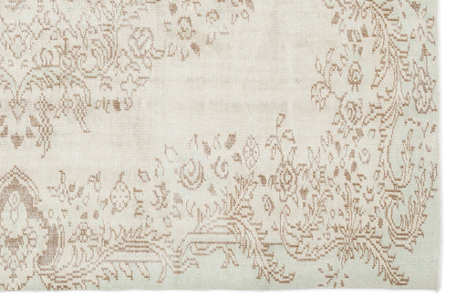 Load image 1 in gallery view. Off-white rug with a faded, light brown floral medallion pattern and distressed texture.