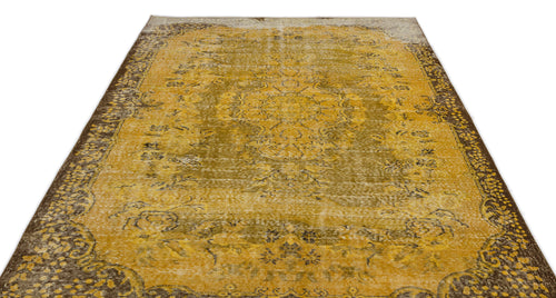 Load image 1 in gallery view. Mustard yellow and brown distressed rug with a traditional central medallion and ornate border on a white background.