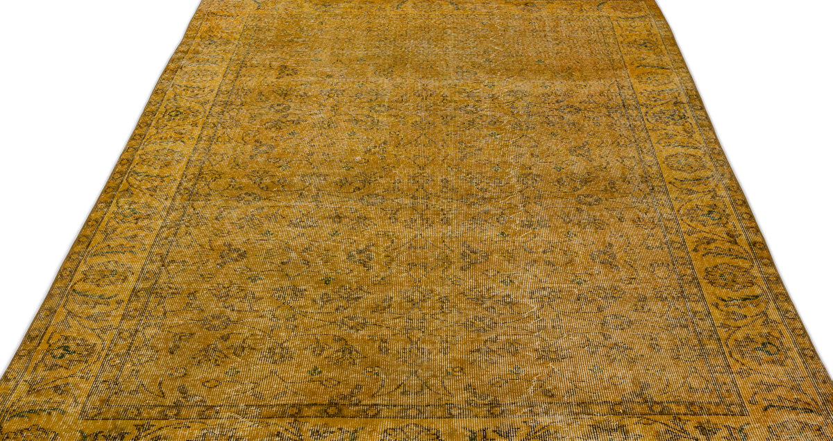Mustard yellow vintage-style rug with a faded floral medallion pattern and a detailed border on a white background.