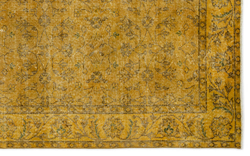 Load image 1 in gallery view. Mustard yellow vintage-style rug with a distressed floral pattern and a decorative border.