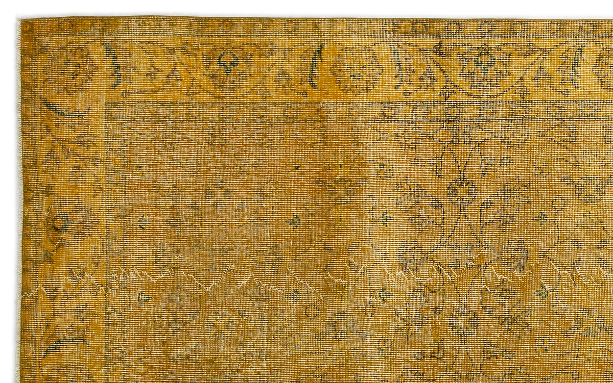 Mustard yellow vintage-style rug with a faded floral medallion pattern and a decorative border.