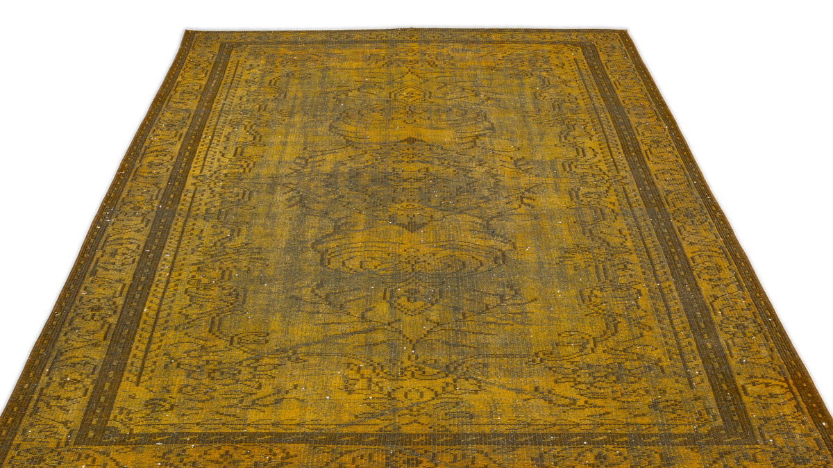 Distressed mustard yellow and charcoal grey traditional rug with a faded central medallion and ornate border.